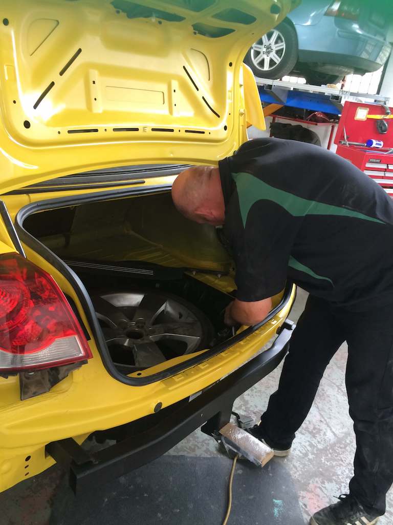 Technician repairing a vehicle